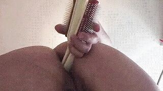 Sliding two hairbrushes into my butt