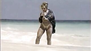 Danni Ashe posing in the waves GIF
