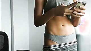 Texting chick exposes her tummy [gif]