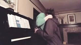 Making out with her friend on the Piano.