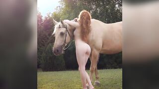 Just Heidi Romanova standing next to a horse