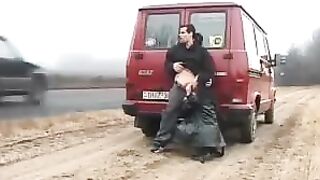 Trashy Couple Having Public Sex in front of a Road with Passing Cars