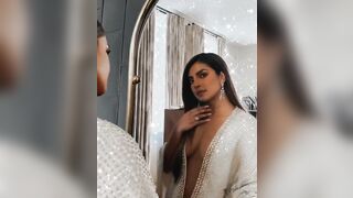 Priyanka Chopra admiring her dress one more time before taking it off for you