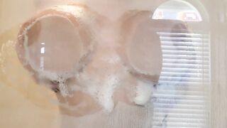 Crystal Lust rubbing her tits against the shower door and twerking