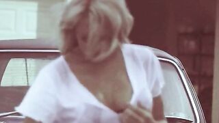Blonde washing a car rips off her wet shirt.