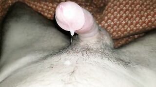 Squeezing out a little stream of cum