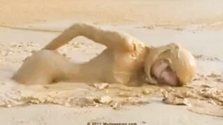 Bringing herself to orgasm in the mud