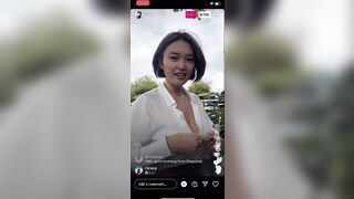 Sheer loose shirt being blown by the wind and revealing bosom. Instagram Live video on February 9, 2022
